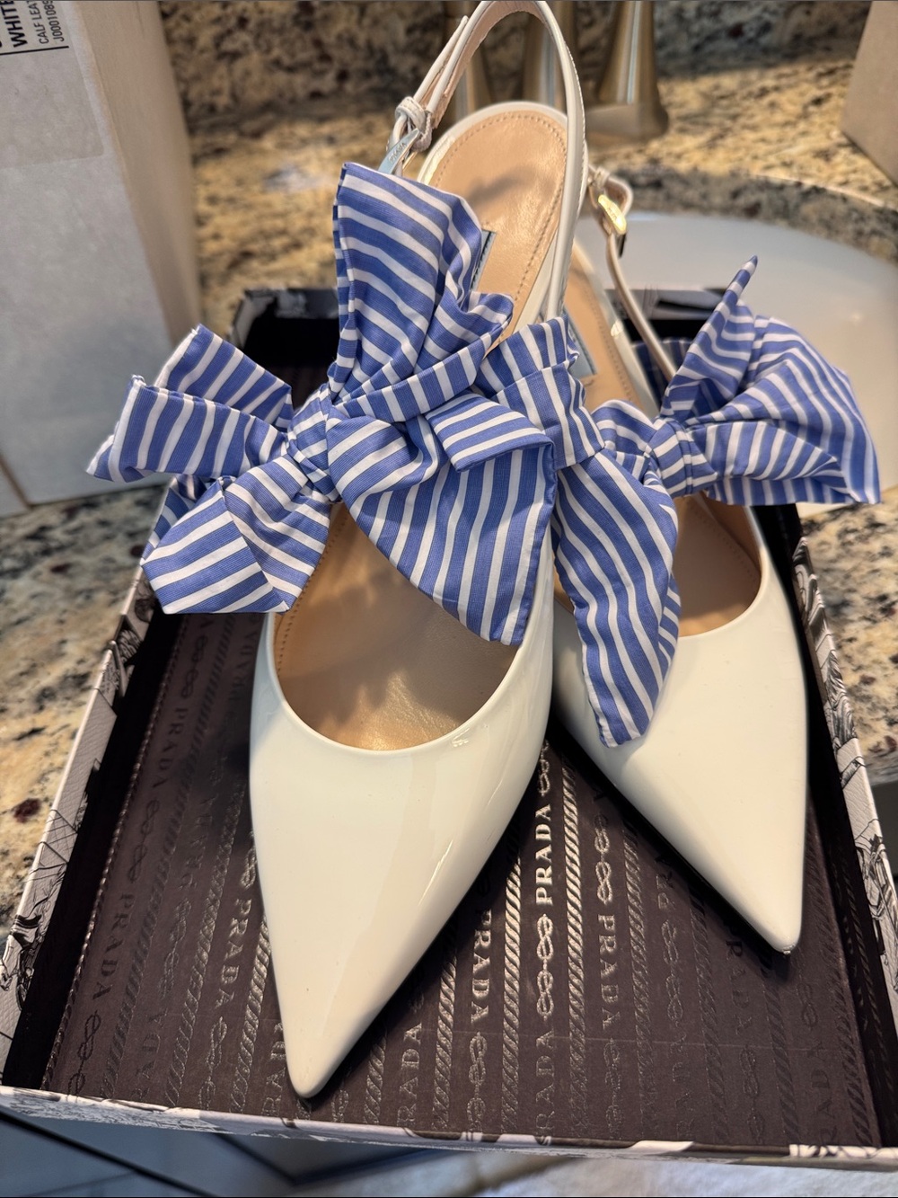 Prada Women's White Patent Leather Slingback Pumps with Blue Striped Bow
